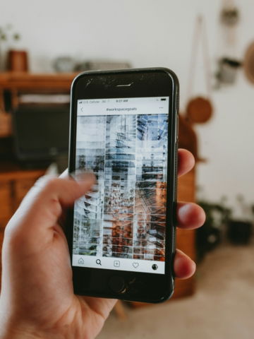 a person holding a cell phone in their hand